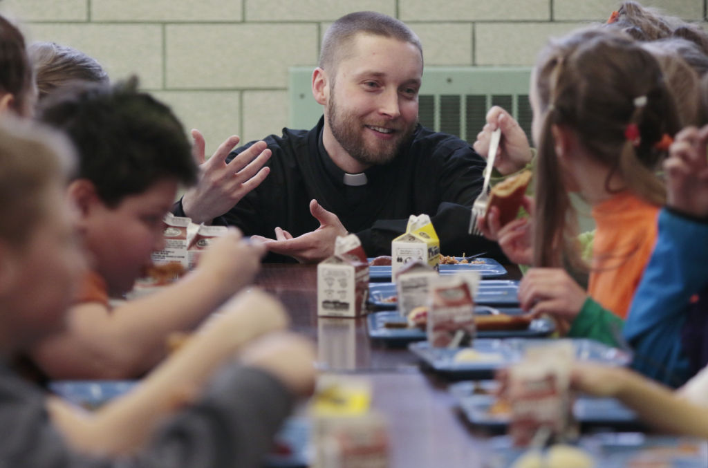 The Rev. Scott Jablonski with school children